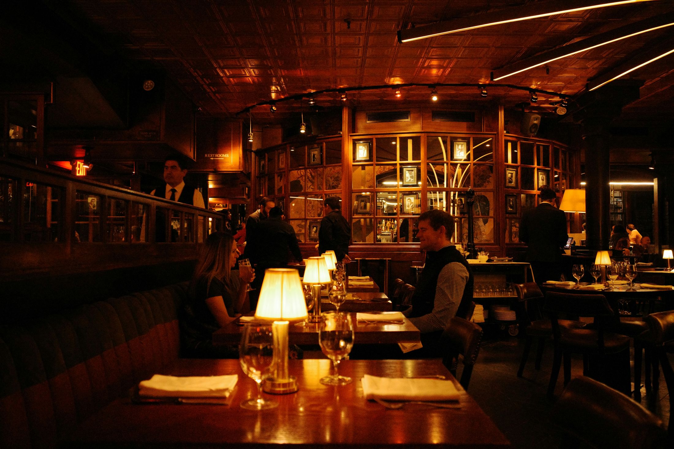 Softly lit dining room at Noir House in the background